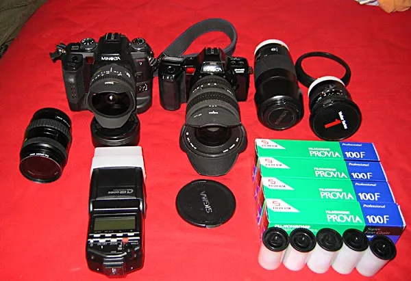 Ready to go - This picture was taken while I was packing for a trip to <a href="/reports/belize2002/">Belize</a>. From my film era, but still representative of what I use: SLR, plenty lenses and an external flash.
